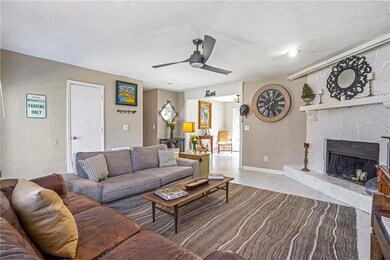 Living room with a ceiling fan and a fireplace
