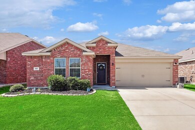 View of front of house with a front yard, a garage