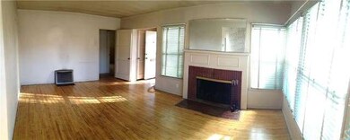 Living room with fireplace and lots of windows