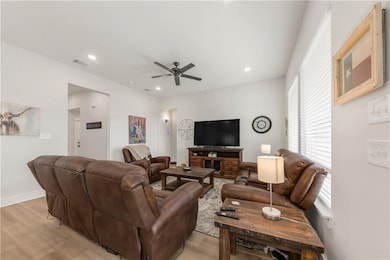Living area featuring light wood-style flooring, a