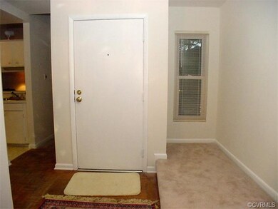 Entrance foyer with wood parquet floor.