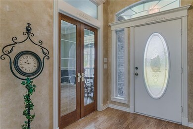 Front entry way and french doors leading into the office; the office has a closet & could be used for 4th bedroom