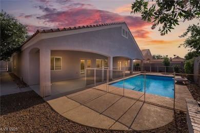 Pool at dusk with a patio