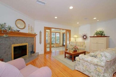 Living room with fireplace & doors to sunporch