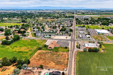 Aerial view of property and surrounding area with a mountainous background