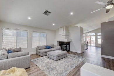 Living room featuring a ceiling fan, lofted ceilin