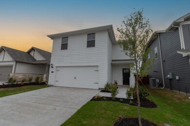 View of front of home featuring driveway, an attac
