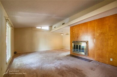 Front living room with a wood burning fireplace as
