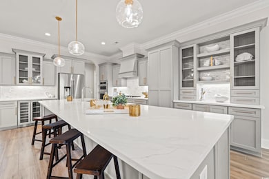 Kitchen featuring a large island, appliances with 