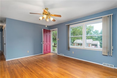 Generous living room space with hardwood floors.