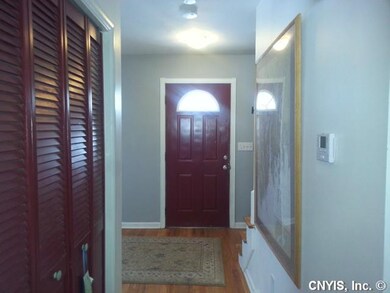 Foyer. Hardwood flooring and updated lighting are 
