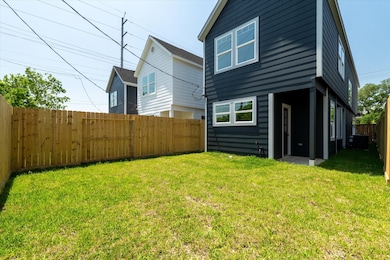 Fully fenced backyard with a covered patio, perfec