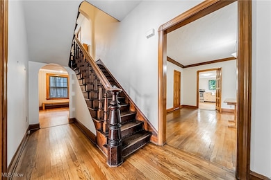 Grand main staircase with a view to the dining room to the right and the study to the left, oak flooring