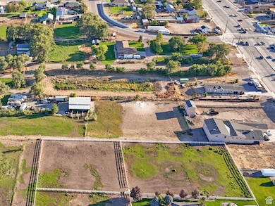 Aerial view of property and surrounding area with nearby suburban area