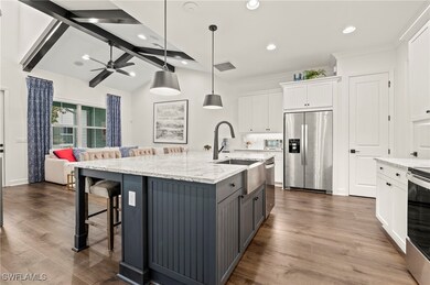 Kitchen featuring white cabinetry, a large island,