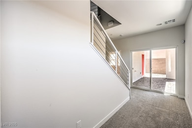 Hallway featuring stairs and carpet flooring