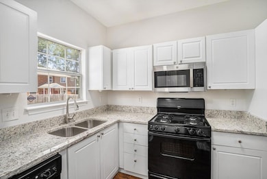 Bright, White Kitchen With Granite Countertops