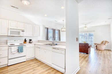 Kitchen featuring pendant lighting, white applianc