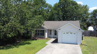 Single story home featuring concrete driveway and a shingled roof
