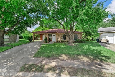 Ranch-style house featuring a carport and a front 