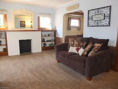 Formal living room with brick fireplace, crown mol