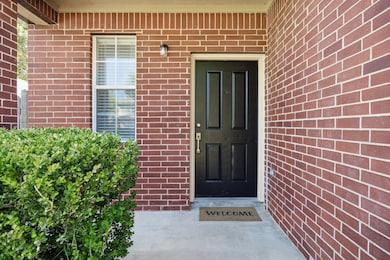 View of exterior entry with brick siding
