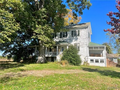 Rear view of property and a yard