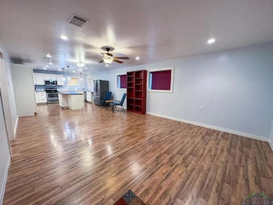 Unfurnished living room featuring light wood-type flooring, ceiling fan, and recessed lighting