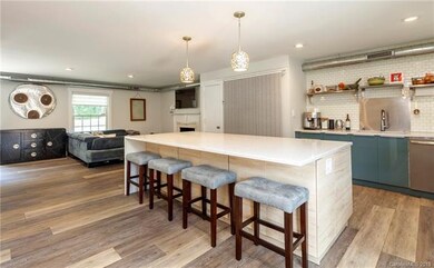 The large quartz kitchen island with waterfall edg