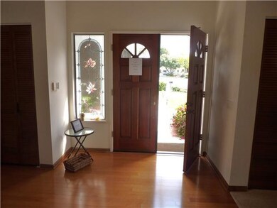 Entry has hardwood floors & stained glass window.