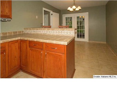 Kitchen bar and dining area with tile floor and fr