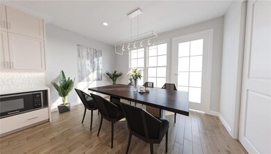 Dining room with baseboards, light wood-type floor