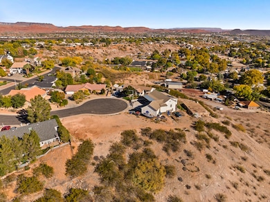 Aerial view of property's location with mountains and nearby suburban area