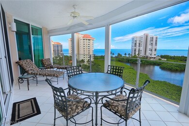 Sunroom / solarium with tile patterned floors and a water view