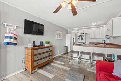Living room with sink, stacked washer and dryer, o