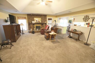 Living room featuring light carpet, a brick firepl