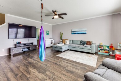 Living room featuring ceiling fan, ornamental mol