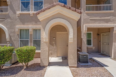 Property entrance with central AC and stucco sidin