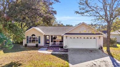 Ranch-style home with a front yard and a garage