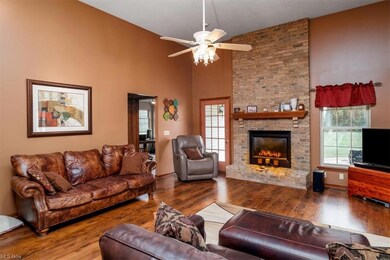 Hardwood floored living room with a fireplace, vau