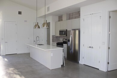 Kitchen with concrete flooring, appliances with s