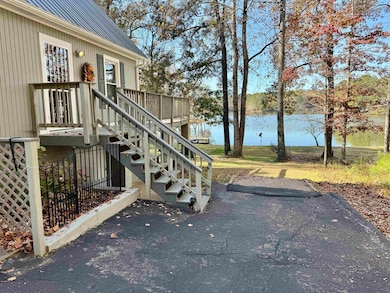 Wooden deck with a water view and stairway