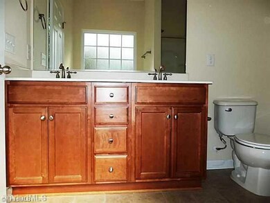 Master Bath/Spa. Master bath has a raised height dual vanity with drawers and cabinets, separate garden tub and shower with hinged door and large walk-in closet.