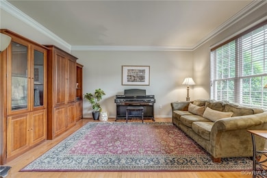 Living area with light wood-type flooring, ornamen