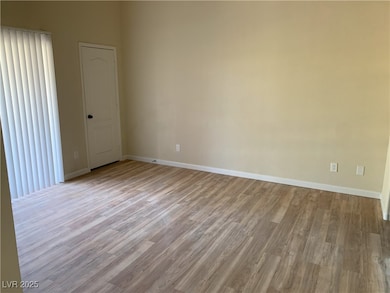 Empty room featuring wood finished floors and base