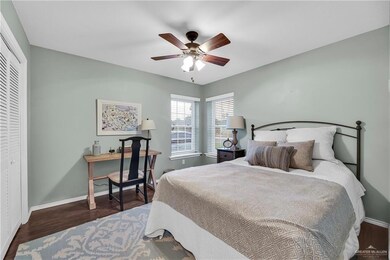 Bedroom with wood finished floors, a closet, and a ceiling fan