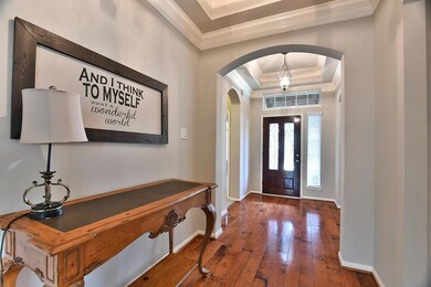 Stunning wide hallway beckons you back to the open living areas.  Beautiful leaded wood door, recent interior paint, and gleaming wood floors enhance the entry.  Notice the amazing crown molding!