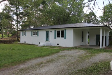 Large one car carport area complete with 6x10 enclosed storage room at back
