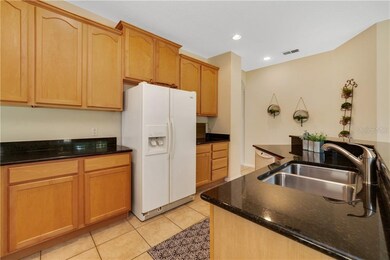 Tons of cabinets with black granite counters.