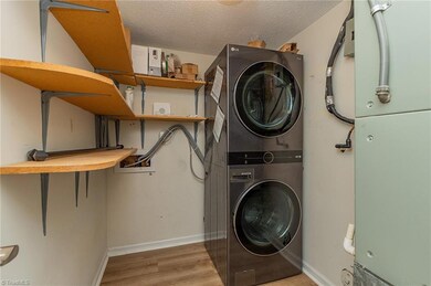 Pantry/laundry sits on the left side of the hallway into the kitchen.